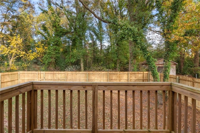 wooden terrace featuring a fenced backyard