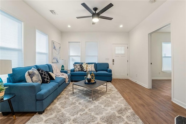 living room with recessed lighting, wood finished floors, a ceiling fan, visible vents, and baseboards