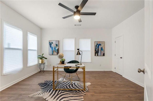 office space with ceiling fan, wood finished floors, visible vents, and baseboards