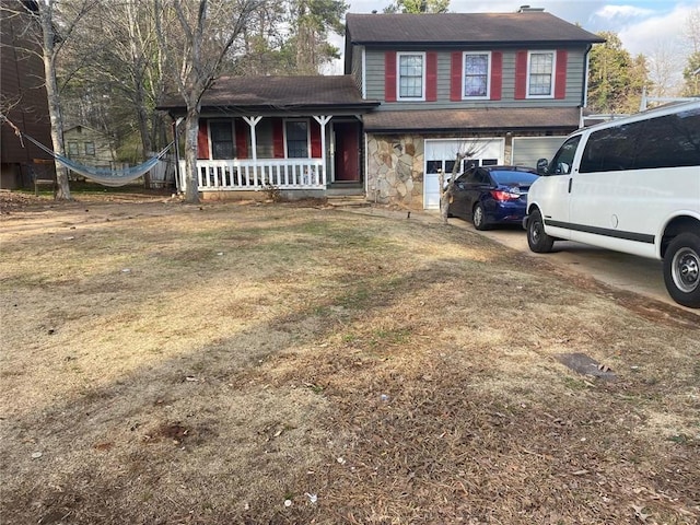 split level home featuring a front lawn and covered porch