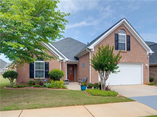 view of front of property with a garage and a front yard