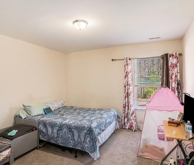 bedroom featuring light carpet