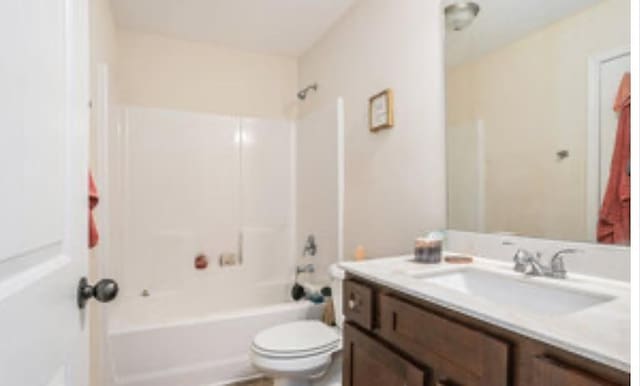 full bathroom with  shower combination, vanity, and toilet