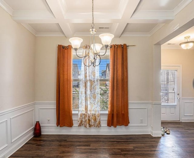 unfurnished dining area featuring coffered ceiling, an inviting chandelier, plenty of natural light, and dark wood-type flooring