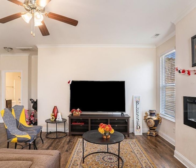 living room featuring ornamental molding, dark hardwood / wood-style flooring, and ceiling fan