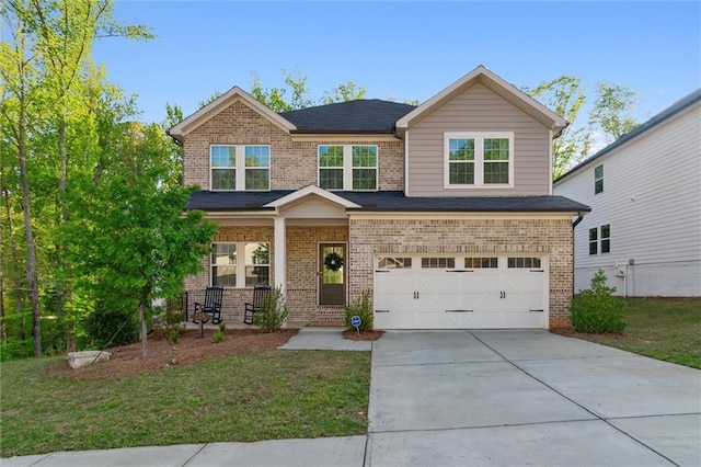 craftsman-style home with brick siding, a garage, a porch, a front yard, and concrete driveway