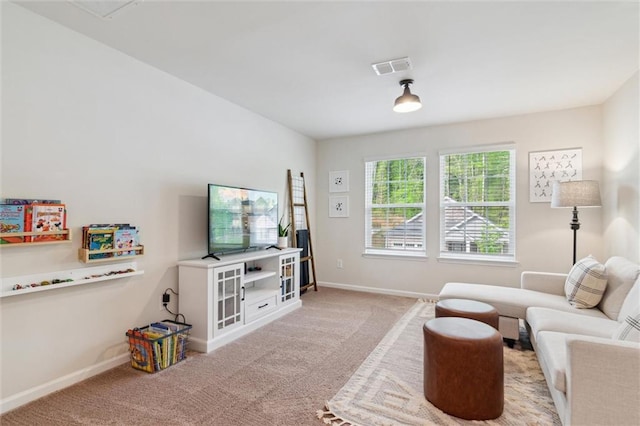 living room with visible vents, baseboards, and carpet floors