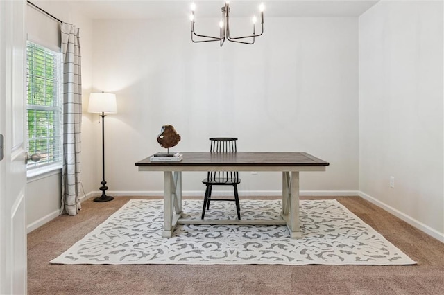 office area featuring carpet floors, baseboards, and an inviting chandelier