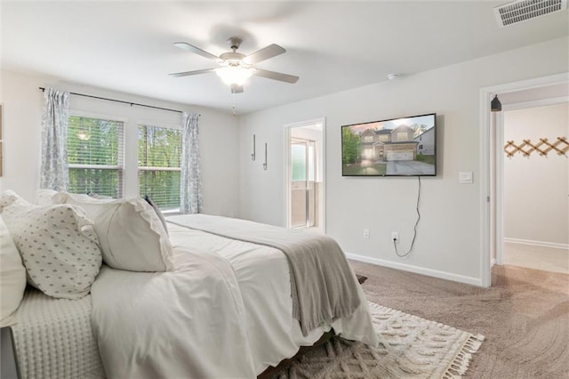 bedroom featuring visible vents, baseboards, ceiling fan, carpet, and ensuite bath