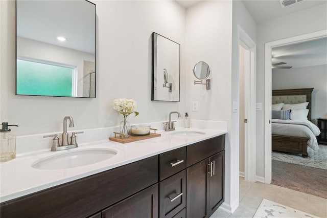 full bath with a sink, tile patterned flooring, double vanity, and connected bathroom