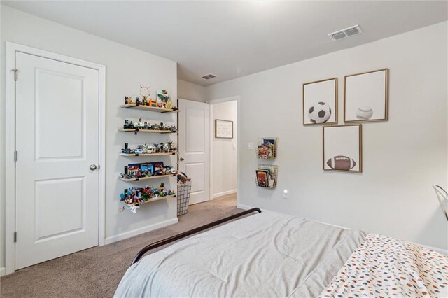 bedroom featuring baseboards, visible vents, and carpet