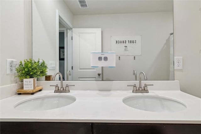 full bathroom with a sink, double vanity, and visible vents