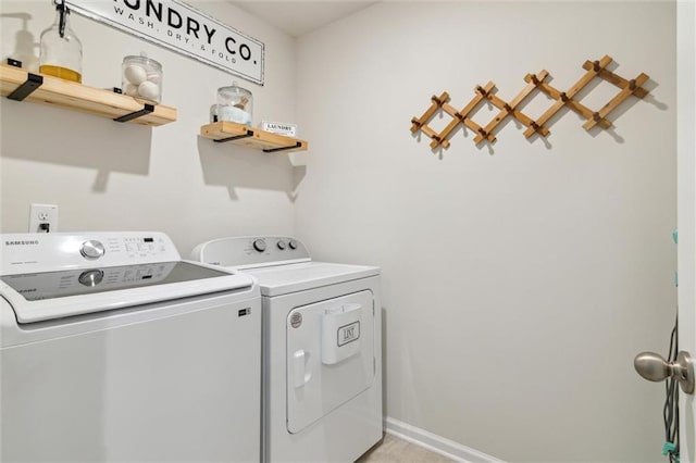 laundry area featuring laundry area, baseboards, and washing machine and clothes dryer