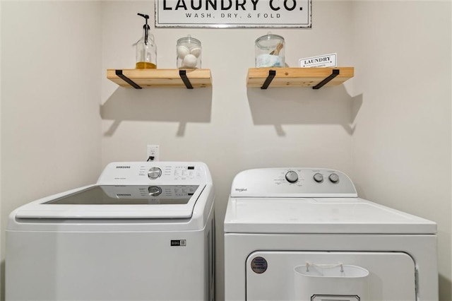 clothes washing area with laundry area and washer and dryer