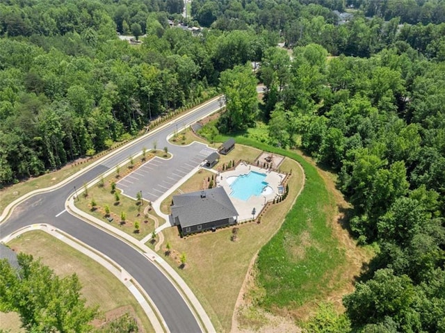 birds eye view of property with a wooded view