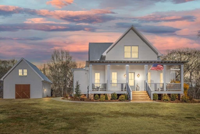 view of front of house featuring a yard, an outdoor structure, and a porch