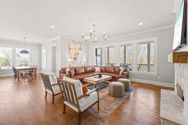 living room with an inviting chandelier, ornamental molding, and wood-type flooring