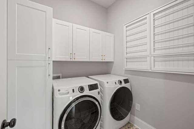 clothes washing area with independent washer and dryer and cabinets