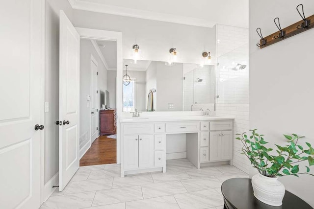 bathroom featuring a shower with door, crown molding, and vanity