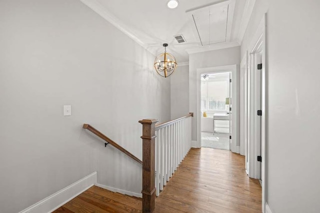 hall with hardwood / wood-style flooring and ornamental molding