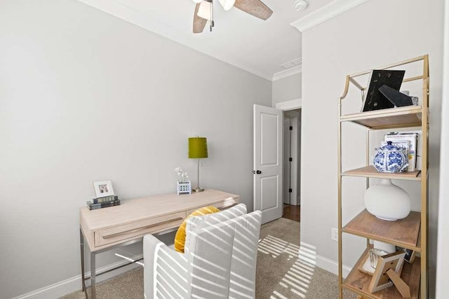 carpeted office featuring crown molding and ceiling fan