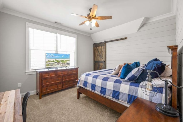 carpeted bedroom with vaulted ceiling, crown molding, a barn door, and ceiling fan