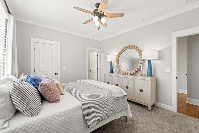 carpeted bedroom with crown molding and ceiling fan