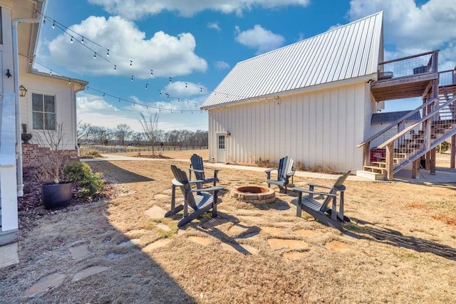 view of yard with an outdoor fire pit