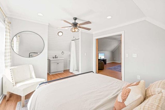 bedroom with ornamental molding, lofted ceiling, ceiling fan, and light hardwood / wood-style flooring