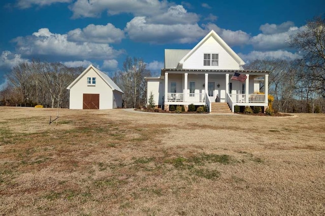 view of front facade featuring an outbuilding, a porch, and a front lawn