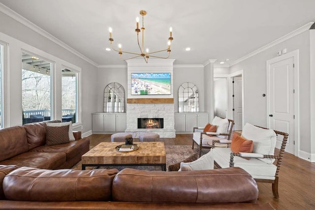 living room featuring crown molding, wood-type flooring, and a stone fireplace