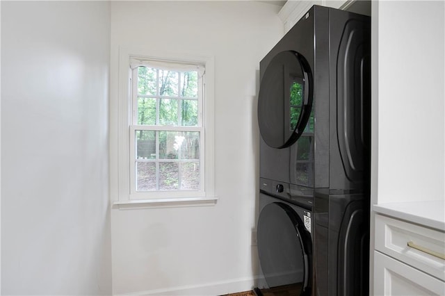 3480 Mount Olive Rd, Atlanta, GA 30344 - washroom featuring stacked washer / drying machine, baseboards, and wood finished floors
