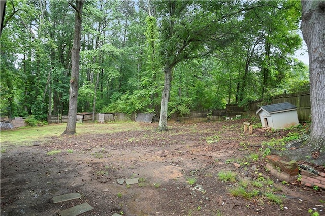 3480 Mount Olive Rd, Atlanta, GA 30344 - fenced backyard featuring a storage unit and an outbuilding