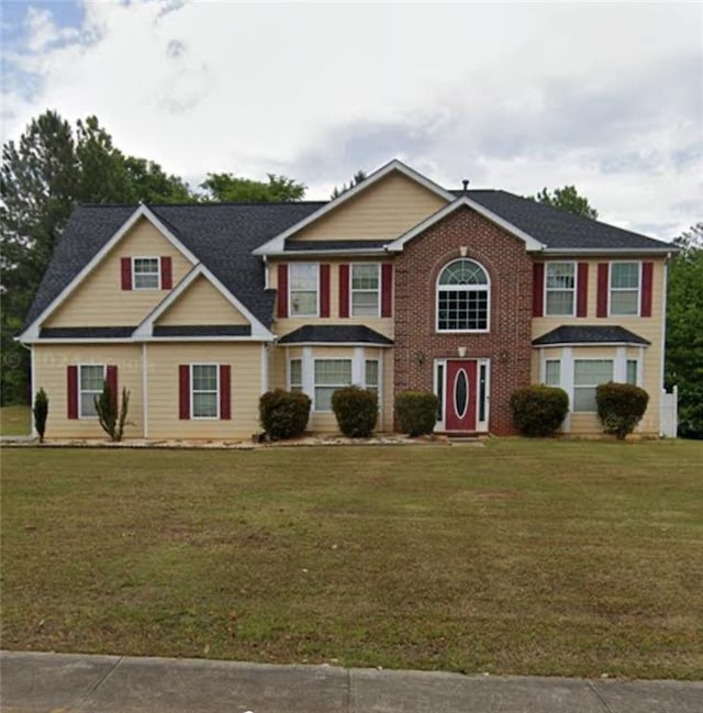 colonial inspired home with a front yard