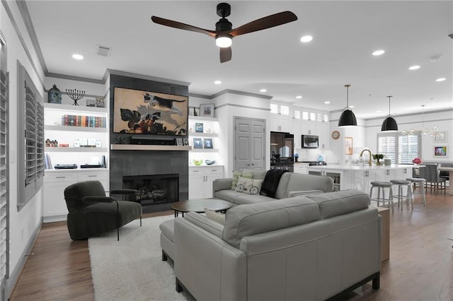 208 Wade Creek Rd, Alpharetta, GA 30009 - living room with crown molding, a ceiling fan, a fireplace, wood finished floors, and recessed lighting