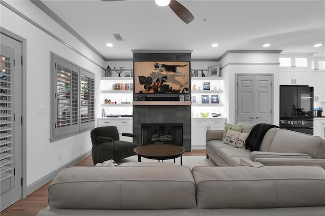 208 Wade Creek Rd, Alpharetta, GA 30009 - living room with ornamental molding, a ceiling fan, a fireplace, recessed lighting, and light wood-style floors