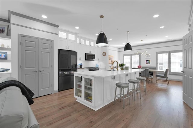 208 Wade Creek Rd, Alpharetta, GA 30009 - kitchen featuring stainless steel microwave, white cabinets, wood finished floors, light countertops, and recessed lighting
