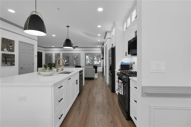 208 Wade Creek Rd, Alpharetta, GA 30009 - kitchen with black appliances, a sink, light countertops, wood finished floors, and recessed lighting