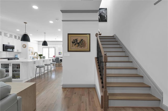 208 Wade Creek Rd, Alpharetta, GA 30009 - staircase featuring recessed lighting, wood finished floors, and baseboards