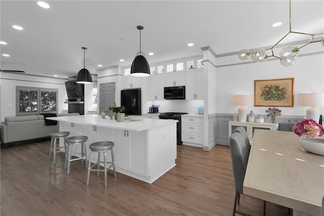 208 Wade Creek Rd, Alpharetta, GA 30009 - kitchen with black appliances, white cabinetry, wood finished floors, open floor plan, and recessed lighting