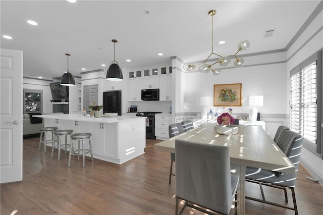 208 Wade Creek Rd, Alpharetta, GA 30009 - dining area with crown molding, plenty of natural light, dark wood-style flooring, recessed lighting, and a chandelier