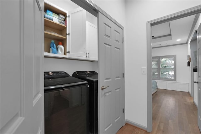 208 Wade Creek Rd, Alpharetta, GA 30009 - laundry room with cabinet space, washing machine and clothes dryer, and light wood-style flooring