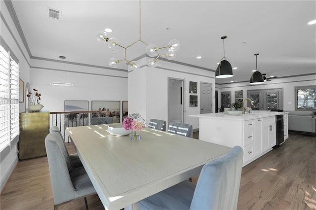 208 Wade Creek Rd, Alpharetta, GA 30009 - dining room featuring wood finished floors, ornamental molding, recessed lighting, and wine cooler
