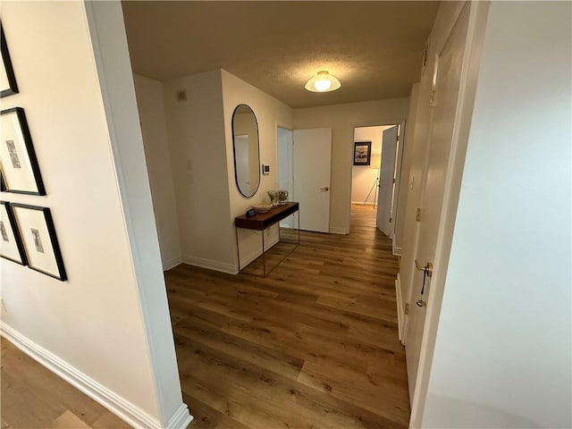 corridor with dark hardwood / wood-style flooring