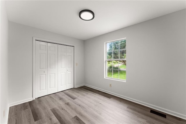 60 Weeping Willow Ln, Dawsonville, GA 30534 - unfurnished bedroom featuring wood finished floors, a closet, and baseboards