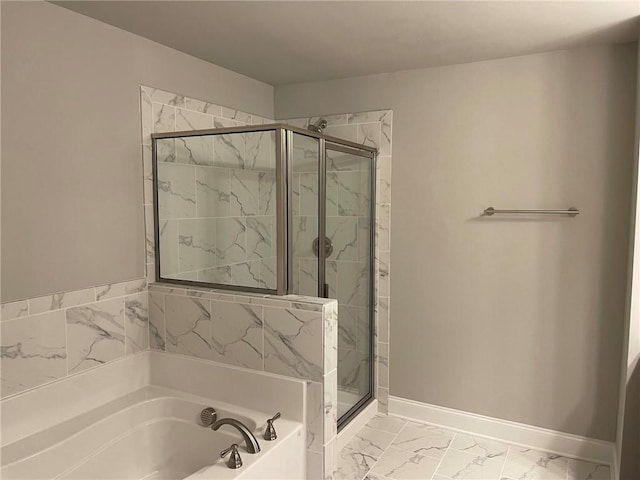 full bath with a bath, a marble finish shower, marble finish floor, and baseboards