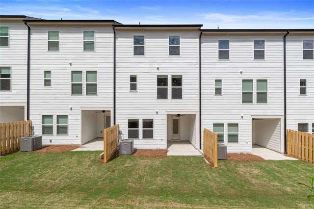 back of property with a yard, a patio, and central AC unit