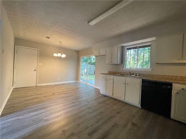 33 Drew Ct, Jonesboro, GA 30238 - kitchen with dishwasher, a chandelier, light wood finished floors, plenty of natural light, and a textured ceiling