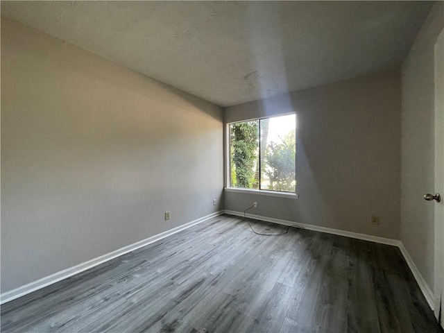 33 Drew Ct, Jonesboro, GA 30238 - spare room with dark wood-style flooring and baseboards