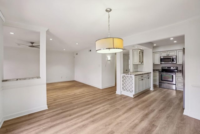 kitchen featuring hanging light fixtures, light wood-type flooring, ceiling fan, and appliances with stainless steel finishes